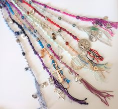 a collection of beads and charms on a white surface