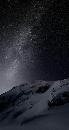 the night sky is filled with stars above a snowy mountain