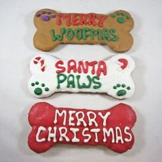 three decorated christmas cookies with dog bone and merry woofmas written on the top