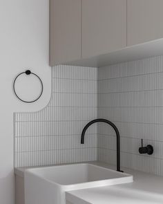 a white kitchen sink sitting under a faucet