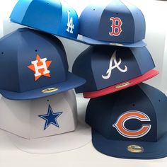 three baseball caps are stacked on top of each other