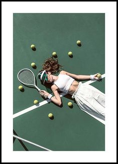 a female tennis player in action on the court with her racket and balls behind her