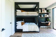 a bunk bed in the corner of a room with bookshelves and shelves on either side