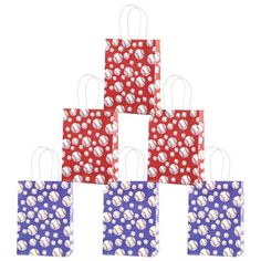 four bags with baseballs on them in red, white and blue colors are stacked up