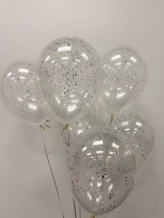 several clear balloons are in the shape of stars