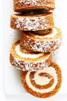 several pastries stacked on top of each other with icing and powdered sugar