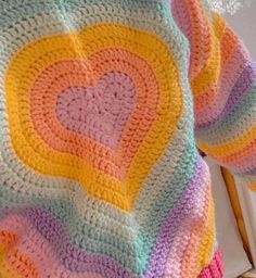 a crocheted blanket with hearts on it