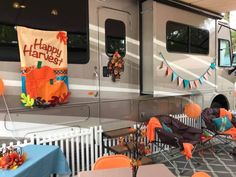 an rv is decorated with orange and blue decorations for the party guests to sit in