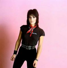 a woman in black and red is posing for the camera