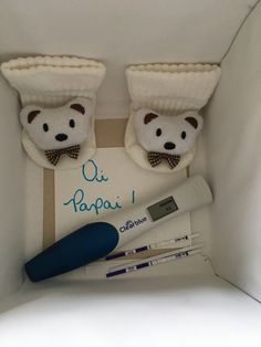 two teddy bears wearing hats and bow ties are in a box with toothbrushes