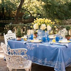 an outdoor table with blue and white decor