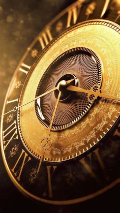 a gold clock with roman numerals and numbers on the face is shown in close up