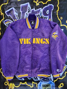 a purple jacket with yellow and white writing on it