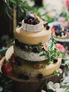 a wedding cake with cheese and fruit on it