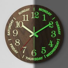 a wooden clock with the words monday and friday on it's face in green