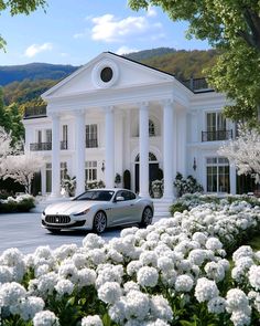 a car parked in front of a large white house with pillars and columns on it