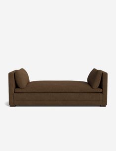 a brown couch sitting on top of a white floor