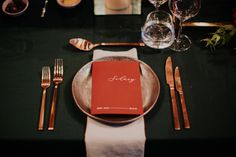 a place setting with silverware and napkins