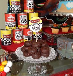 a table topped with lots of chocolate covered donuts and other desserts on top of it