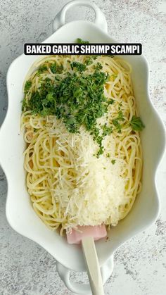 a white bowl filled with noodles and parmesan cheese