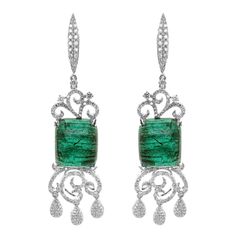 A massive pair of 25.45 carat of vivid green emerald are set along with 1.78 carat of white brilliant round diamond. The gorgeous dangle earring is a must wear for all red carpet events. The details of the earring are mentioned below: Color: F Clarity: VS