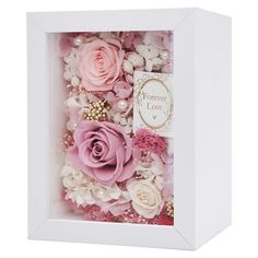 a white box with pink flowers and pearls on the inside is holding a card that says forever love