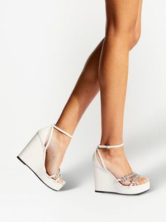 Luxury Wedge Sandals With Buckle Closure, Luxury Spring Wedge Sandals With Buckle Closure, White Open Heel Wedge Sandals For Evening, White Leather Wedge Sandals For Party, Crystal Embellished Wedge Heel Sandals, Glamorous Leather Wedge Sandals, Glamorous White Platform Sandals, Luxury White Synthetic Sandals, Luxury White Wedge Heel Sandals