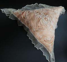 a decorative piece of cloth with lace on it