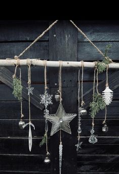 a star hanging from the side of a building with ornaments on it's sides