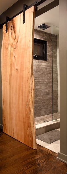 a large piece of wood sitting on top of a wooden floor next to a glass door