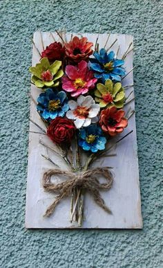 a bunch of flowers tied to a piece of wood