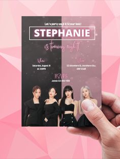 a hand holding up a pink and black flyer for a fashion show with three models