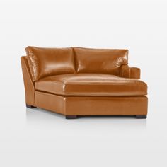 a tan leather couch with an ottoman