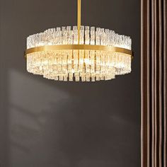 a chandelier hanging from the ceiling in a room with dark walls and curtains