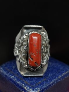 This stunning vintage ring has incredible unique style, the ring originates from Tibet where tribal jewellery is a highly skilled roll. This item would have been crafted for the tourist market in the early to mid 20th century and features large natural coral gemstone set in sterling silver saddle ring.  UK size - W1/2 US size - 11.25 length approx - 30mm Message me any questions  ITEM - S1390 Vintage Adjustable Engraved Ceremonial Ring, Handmade Vintage Open Engraved Ring, Vintage Handmade Rings For Ceremonial Occasions, Unique Carved Ring Jewelry, Red Carved Vintage Jewelry, Vintage Open Ring For Ceremonial Occasions, Vintage Adjustable Carved Ring, Vintage Ceremonial Open Ring, Carved Red Vintage Jewelry