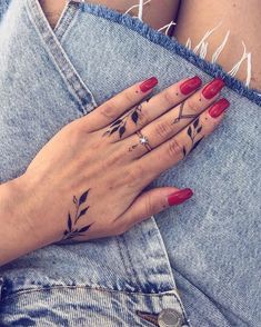 a woman's hand with tattoos on it