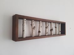 a group of birch trees mounted on a wall