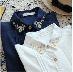 three different types of clothing laid out on a lace doily with a straw hat