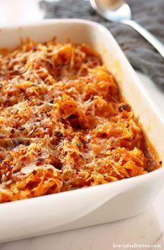 a casserole dish with cheese and meat in it