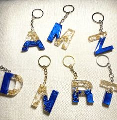 six different type of key chains with letters on them