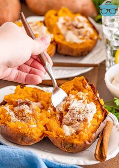 a person is spooning some food out of a baked sweet potato dish on a plate