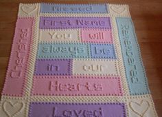 a crocheted blanket with words and hearts on it