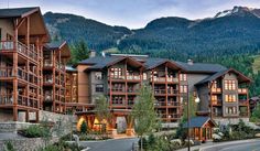 a large building with many balconies in the mountains