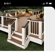 an outdoor deck with white railings and wooden steps