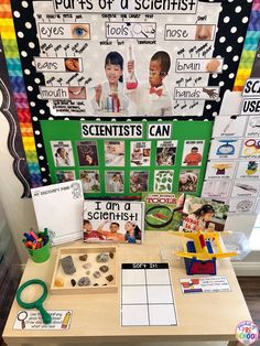 a table topped with lots of different types of science materials and posters on it's walls