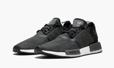 The adidas NMD R1 bridges the gap between tech performance and streetwear style.  The NMD R1 has a mesh upper that gives it a unique texture while also delivering a sock-like fit.  Different shades of black are deployed on the upper to give the sneaker a dynamic visual appeal that is complemented by the white Boost midsole and the NMD's signature EVA plugs. Adidas Nmd R1 Black, Different Shades Of Black, Adidas Nmd R1, Nmd R1, Stadium Goods, Adidas Nmd, Streetwear Style, Carbon Black, Adidas Tubular Defiant