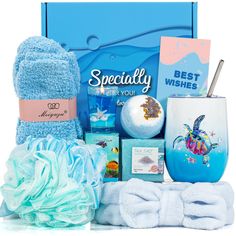 a blue gift box with towels, soaps and other items