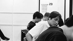 black and white photograph of people waiting in line