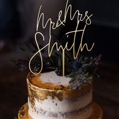 a white and gold wedding cake with the words ms & m's smith on top