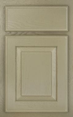 a close up view of an unfinished kitchen cabinet door with white painted woodgrain